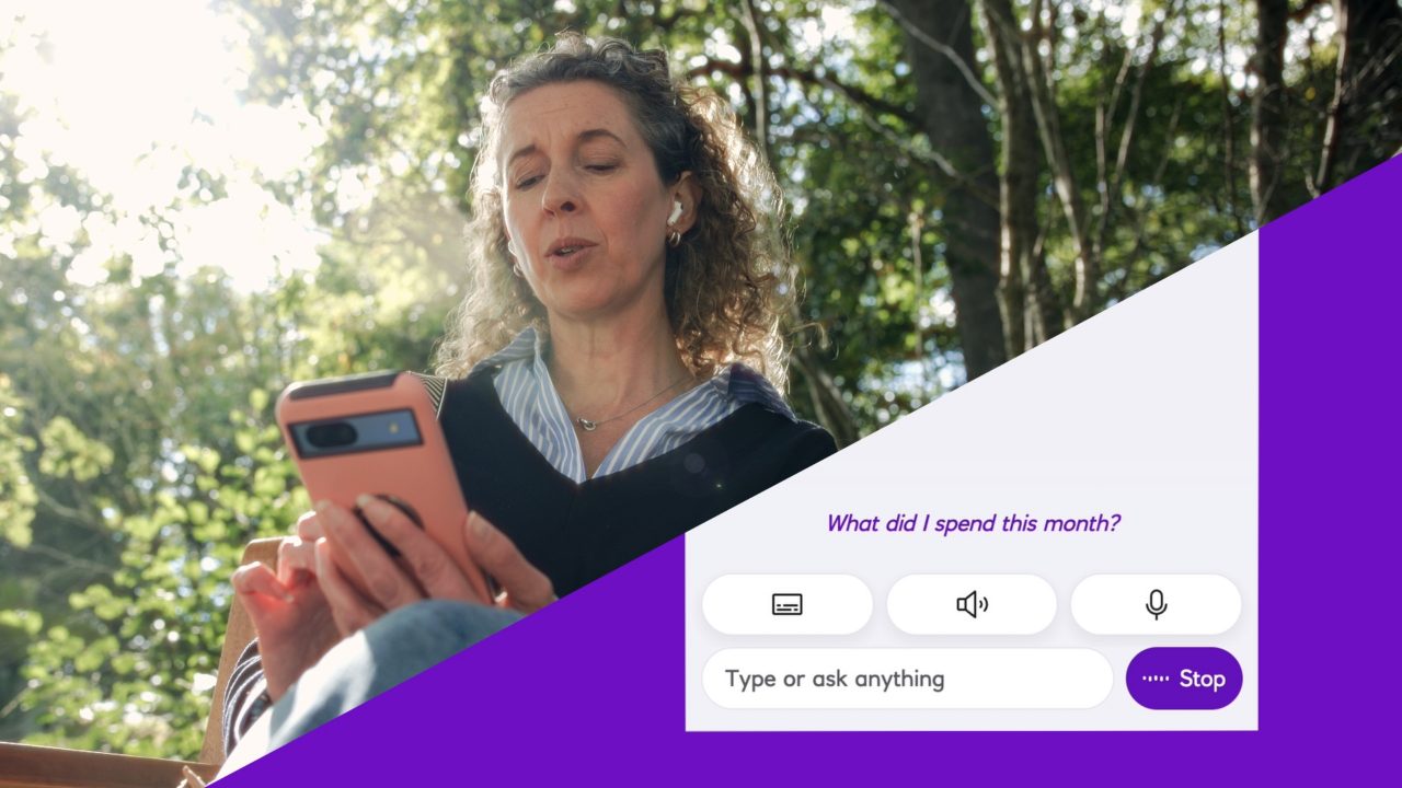 This image shows a woman looking at her phone and engaging with NatWest’s spending insights tool.