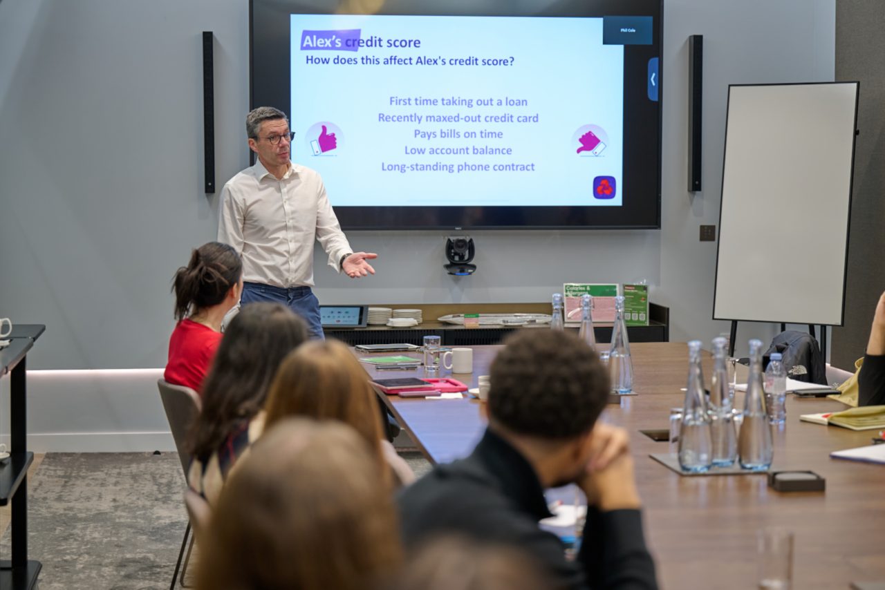 a Man in a white shirt and glasses teaching a class