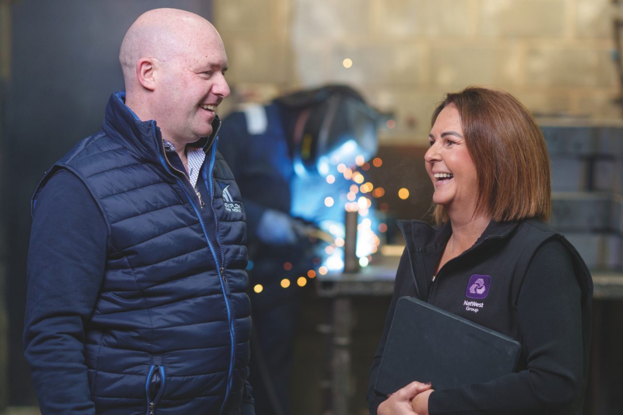 This image shows a NatWest colleague with a business customer 