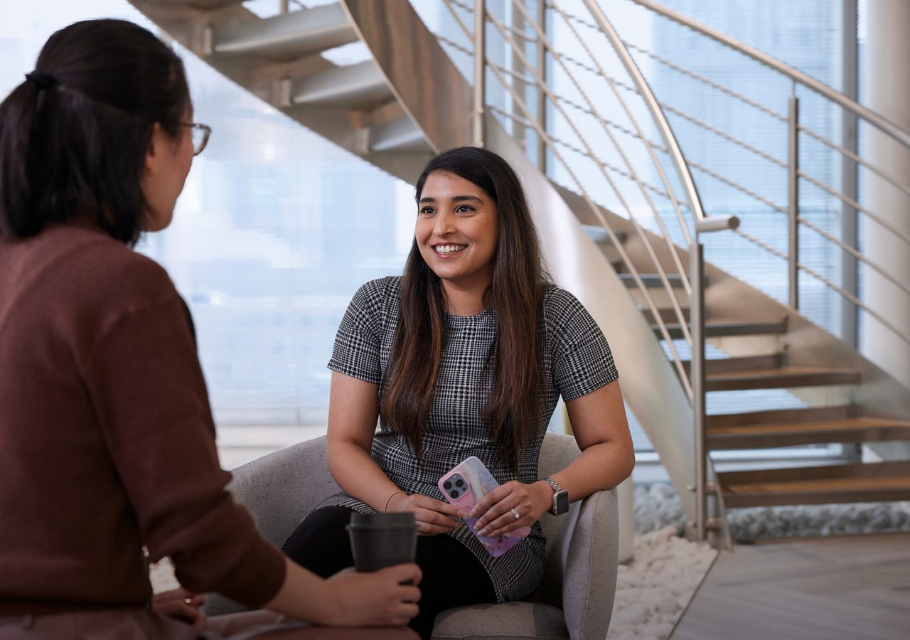 Two women in conversation at Spinningfields, Manchester office 