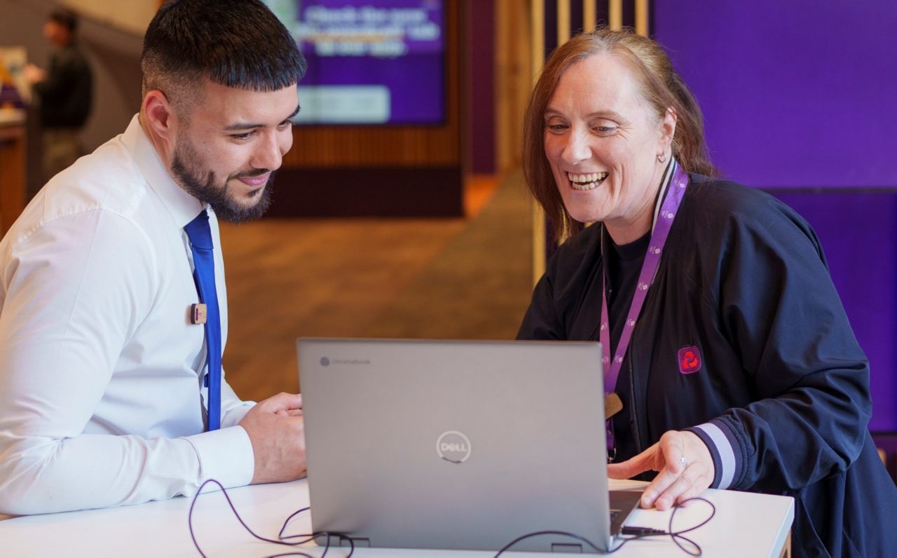 this image shows two NatWest Group colleagues in a branch looking at a computer