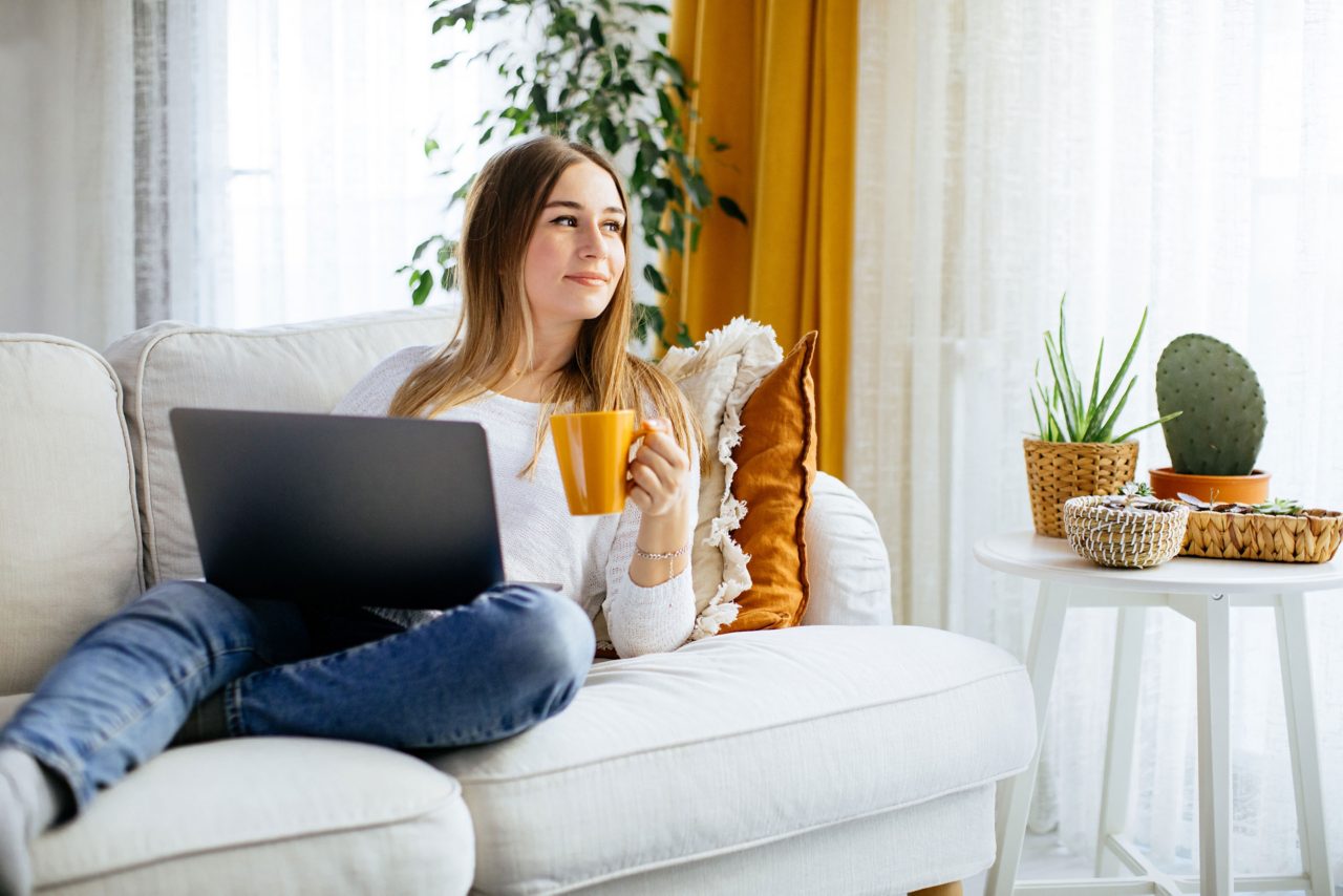 Woman sitting on sofa reading