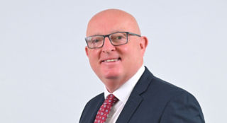 Martin Convery, white male, bald, grey framed glasses, blue eyes